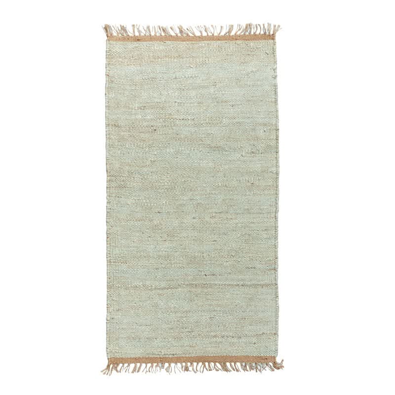 Handwoven Jute Rug - Natural & Rustic. Light beige jute rug with fringe, textured weave.
